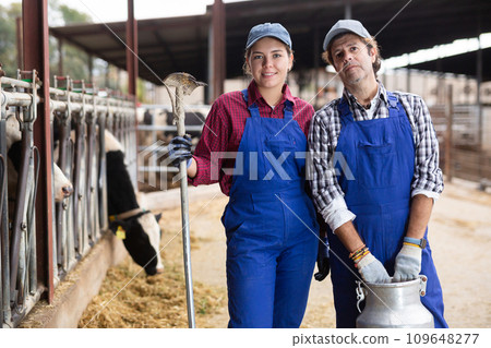 Portrait of man and woman farmers on dairy farm 109648277