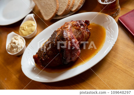 Baked pork knuckle with horseradish, mustard, bread 109648297
