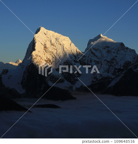 Sun lit peak of Mount Cholatse at sunset, Nepal. 109648516