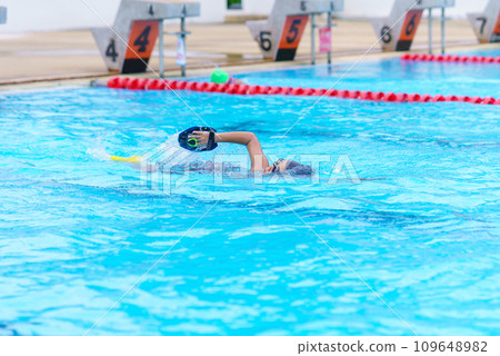 child swimmer swim in swimming pool. Water sports training and competition, learning to swim classes for children child swimmer swim in swimming pool. Water sports training and competition, learning to swim classes for children 109648982