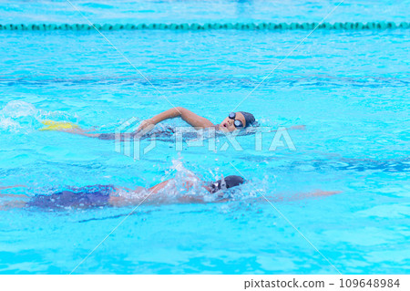 child swimmer swim in swimming pool. Water sports training and competition, learning to swim classes for children 109648984