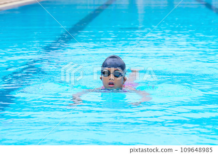 child swimmer swim in swimming pool. Water sports training and competition, learning to swim classes for children 109648985