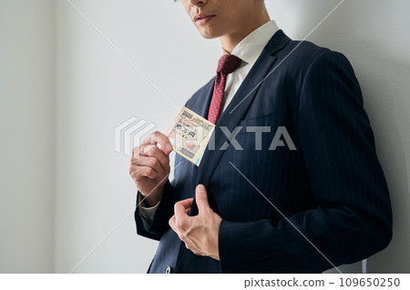 A man who puts a bundle in his pocket A man who puts a bundle in his pocket 109650250