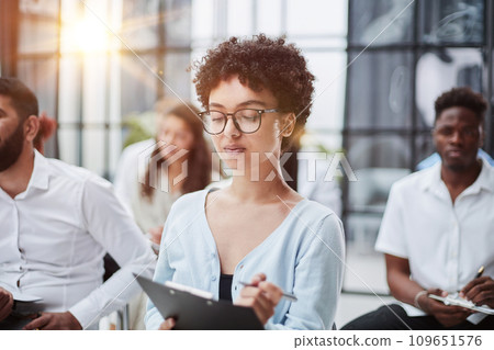 Group of different employees studying at board meeting in modern office or conference room Group of different employees studying at board meeting in modern office or conference room 109651576