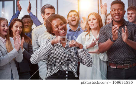 Business team celebrating a triumph with arms up Business team celebrating a triumph with arms up 109651580