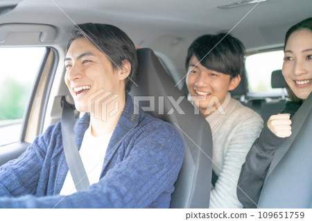 Young men and women enjoy driving around in a shared car 109651759