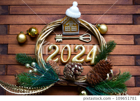 House key with keychain cottage on festive brown wooden background with stars, lights of garlands. New Year 2024 wooden letters, greeting card. Purchase, construction, relocation, mortgage, insurance House key with keychain cottage on festive brown wooden background with stars, lights of garlands. New Year 2024 wooden letters, greeting card. Purchase, construction, relocation, mortgage, insurance 109651781
