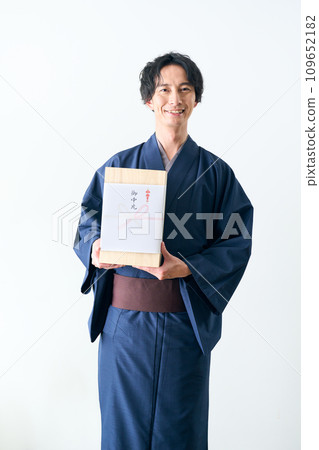 A man offering a midyear gift A man offering a midyear gift 109652182