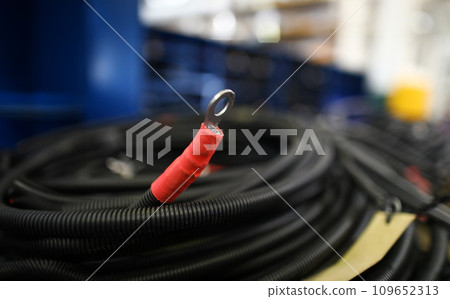 Piece of electric cable with terminal lying at warehouse Piece of electric cable with terminal lying at warehouse 109652313
