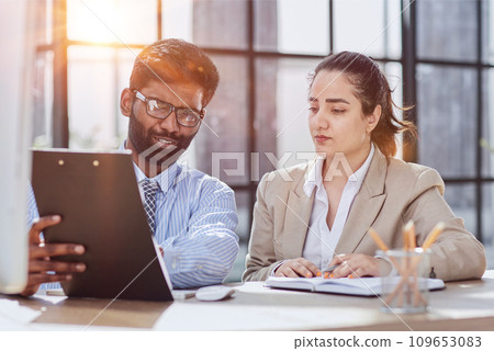 Startup business partners working together in desktop 109653083