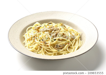 Vongole Bianco with lots of clams, red chili peppers, Italian parsley, and garlic chips photographed against a white background 109653555