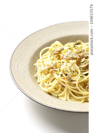 Vongole Bianco with lots of clams, red chili peppers, Italian parsley, and garlic chips photographed against a white background 109653579