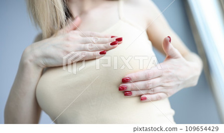 Woman palpating her breasts with hands closeup 109654429