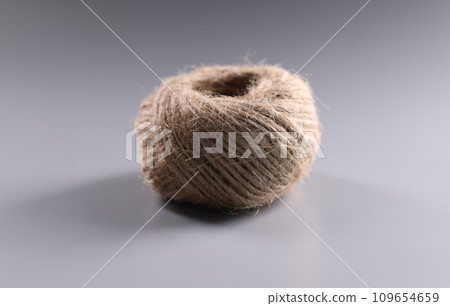 Brown rope roll, skein of jute twine on grey background 109654659