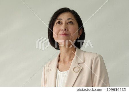 戴著珍珠胸針的微笑中年婦女 109656585