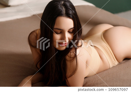 Beautiful sexy brunette woman lying. Perfect slim Beautiful sexy brunette woman lying. Perfect slim 109657097