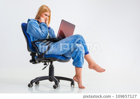 girl in pajamas with a laptop girl in pajamas with a laptop 109657127