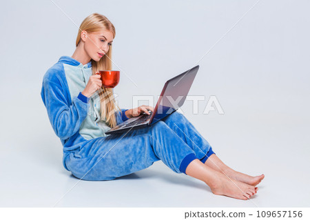 girl in pajamas with a laptop girl in pajamas with a laptop 109657156