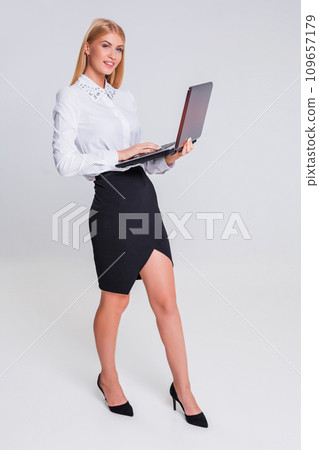 Young businesswoman working at laptop computer. Young businesswoman working at laptop computer. 109657179
