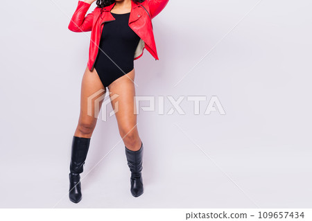 Sensual beautiful african ethnic woman in bodysuit posing in studio isolated on red white background 109657434