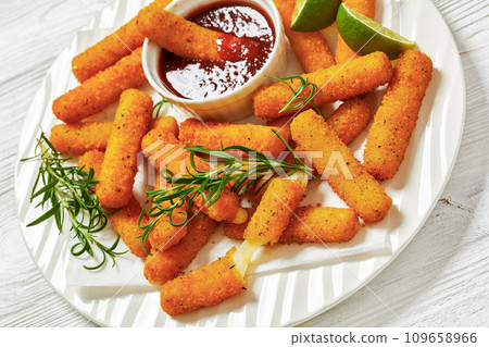 fried mozzarella sticks with sauce on white plate 109658966