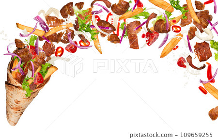 Close-up of kebab sandwich with flying ingredients. Freeze motion. Close-up of kebab sandwich with flying ingredients. Freeze motion. 109659255