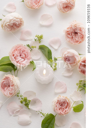 Pink roses and candles in the shape of a heart 109659336