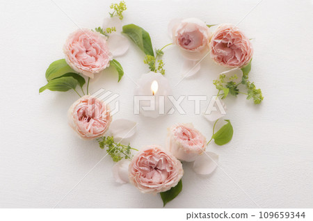 Pink roses and candles in the shape of a heart Pink roses and candles in the shape of a heart 109659344