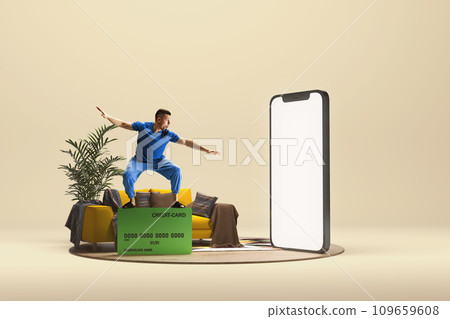 Man surfing on credit cards near giant 3D model of Mobile phone screen over light background. Online payment, wireless cash, shopping 109659608