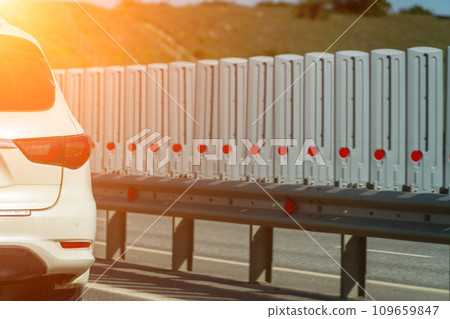 Safety barriers on highway. Anodized safety steel barrier. Enhancing highway safety. Safety barriers on highway. Anodized safety steel barrier. Enhancing highway safety. 109659847