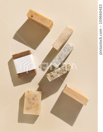 Beige and brown soap bars on light beige top view, hard shadows, packaging mockup 109660483