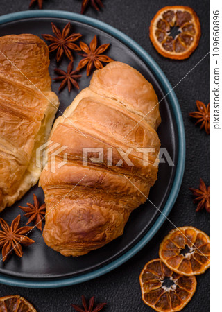 Delicious crispy baked sweet croissants with filling on a ceramic plate 109660896