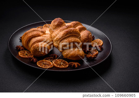 Delicious crispy baked sweet croissants with filling on a ceramic plate 109660905