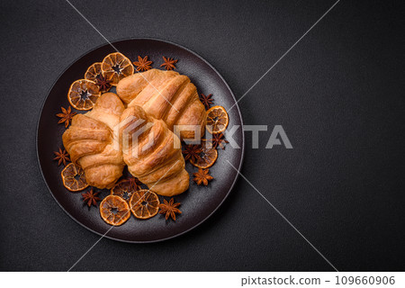 Delicious crispy baked sweet croissants with filling on a ceramic plate Delicious crispy baked sweet croissants with filling on a ceramic plate 109660906