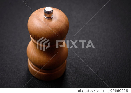 Beautiful wooden figured pepper shaker or salt shaker with a mill 109660928