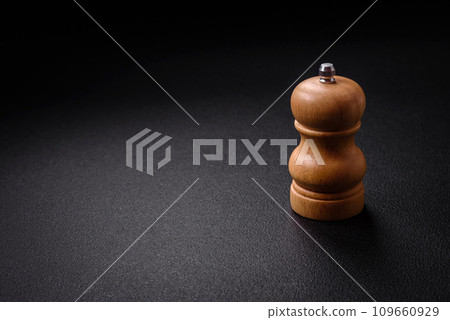 Beautiful wooden figured pepper shaker or salt shaker with a mill 109660929