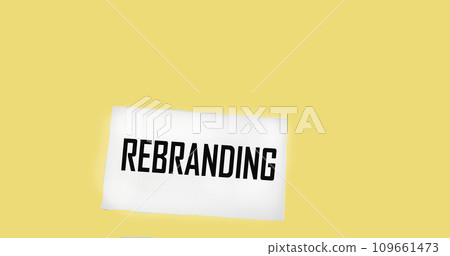 The text REBRANDING appearing behind torn brown paper 109661473