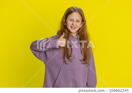 Happy preteen child girl kid looking approvingly at camera showing thumbs up, like positive sign Happy preteen child girl kid looking approvingly at camera showing thumbs up, like positive sign 109662245