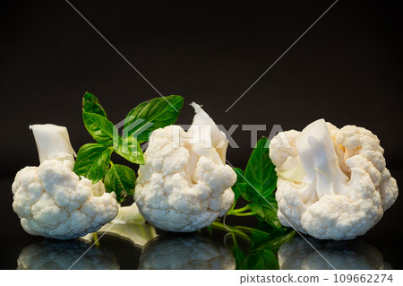 slices of raw small raw cauliflower on black background 109662274