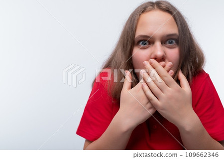 Headshot portrait of a European teenage girl with a surprised expression Headshot portrait of a European teenage girl with a surprised expression 109662346