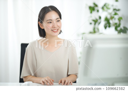Young business woman working at a computer in the office Young business woman working at a computer in the office 109662382