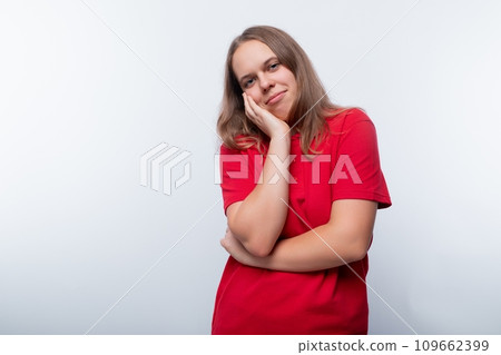 Modest teenager girl hiding her face on a white background 109662399