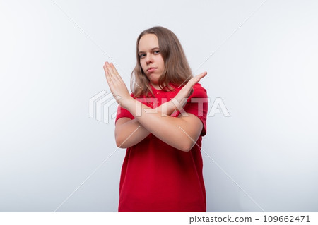 Teen girl crossed her arms in front of her 109662471