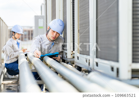 Engineer inspecting piping Engineer inspecting piping 109663521