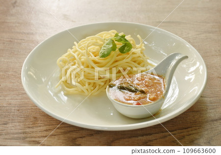 boiled spaghetti dressing spicy fried chop chicken with chili and basil sauce on plate boiled spaghetti dressing spicy fried chop chicken with chili and basil sauce on plate 109663600