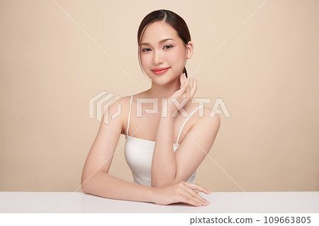 Beautiful young asian woman with clean fresh skin on beige background, Face care, Facial treatment, Cosmetology, beauty and spa, Asian women portrait. 109663805