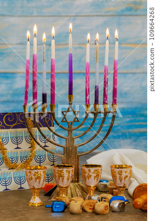 Hanukkah menorah is symbol of Hanukkah that depicts burning candles on menorah during holiday 109664268