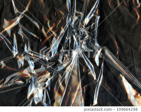 Transparent crumpled plastic textures contrasted against a black canvas. Background for design. 109664298