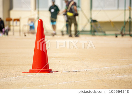 Colored cones on the corner of the track at a sports day Colored cones on the corner of the track at a sports day 109664348