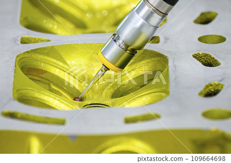The multi axis CMM machine measuring the aluminum cylinder head parts. 109664698